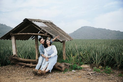 Man And Woman Sitting On A Log