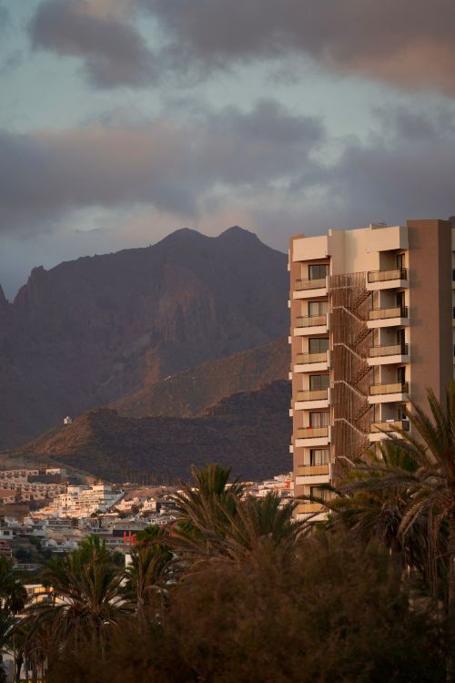 Free Mountainous landscape in Arona, Canary Islands with modern buildings at sunset. Stock Photo