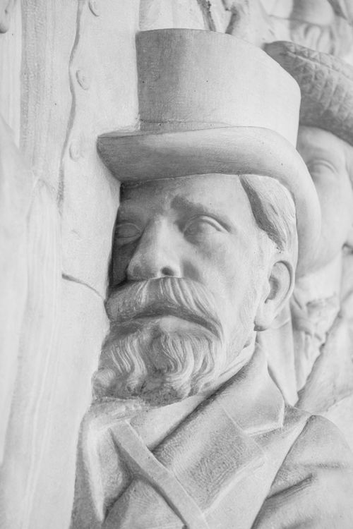 Free Close-up view of historical stone carving of a man in a top hat. Artistic and classic style. Stock Photo