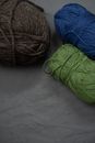 Blue and Green Yarn on White Textile