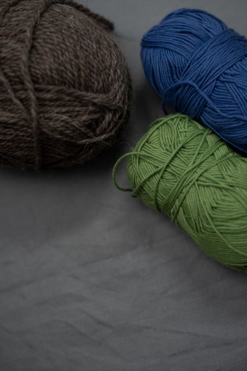 Free Soft yarn balls in earthy tones, perfect for knitting cozy crafts. Stock Photo