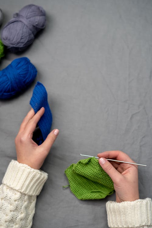 Person Holding Blue Yarn Roll