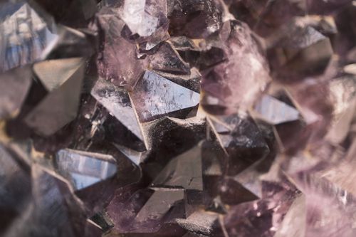 Free Detailed view of amethyst crystals showcasing their purple hues and intricate facets under natural lighting. Stock Photo