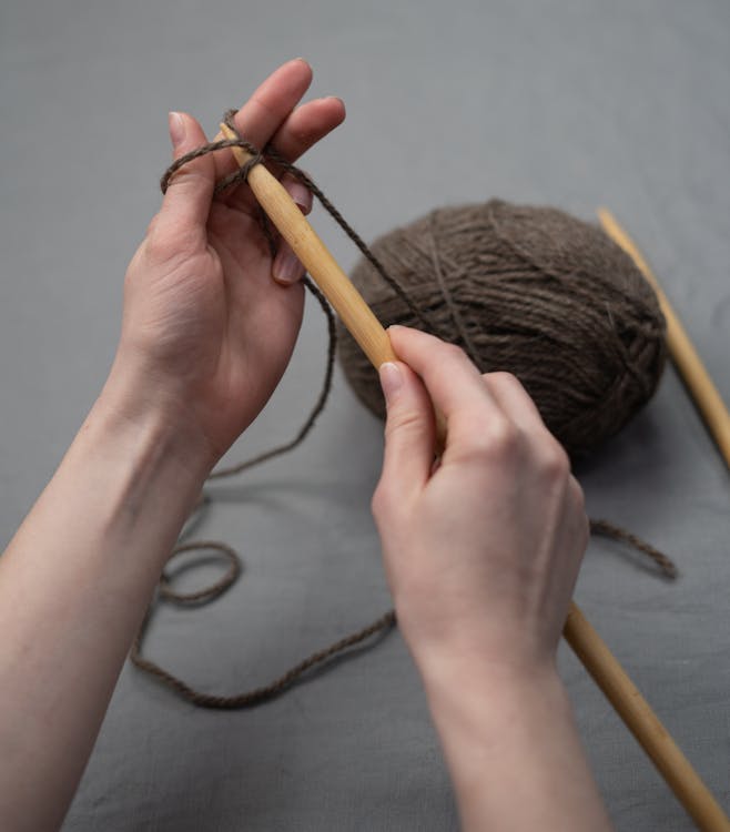 Person Holding Brown Yarn Roll