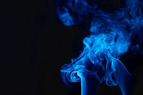 Free Vibrant blue smoke swirling against a black backdrop, creating a mystical and abstract design. Stock Photo