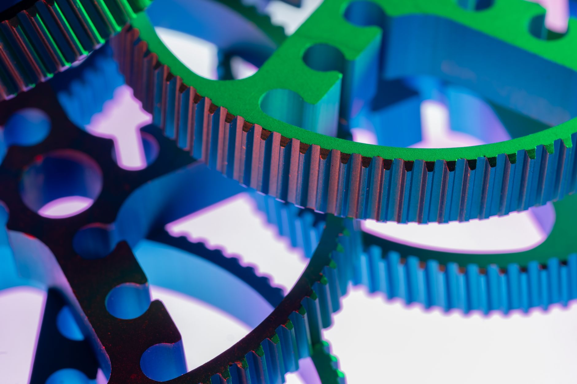 Vividly colored metal gears in a close-up shot, emphasizing industrial precision and mechanical design.