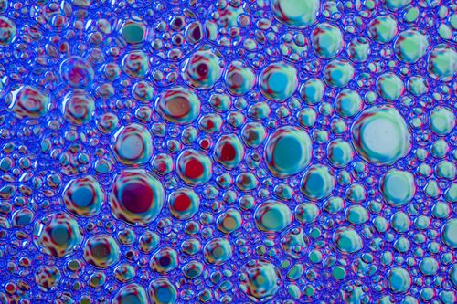 Free Captivating abstract of vibrant blue and multicolored bubbles, creating a mesmerizing pattern. Stock Photo