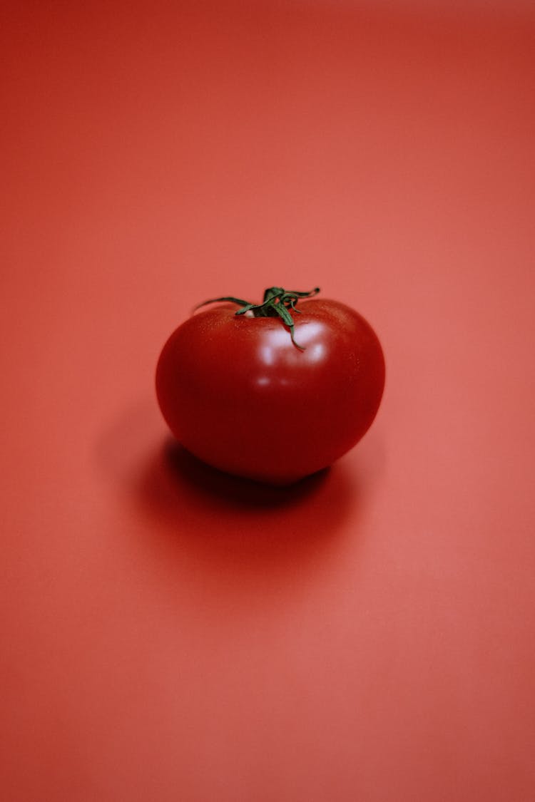 Red Tomato On Red Surface