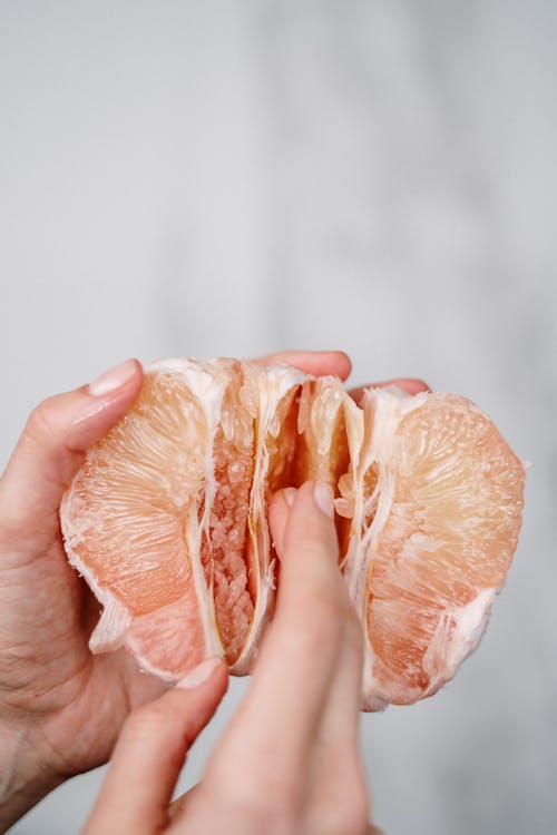 Person Holding Sliced Orange Fruit