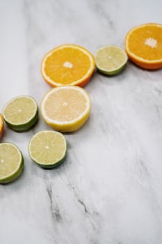 Fresh citrus slices arranged on marble, highlighting vibrant colors and textures for healthy food themes.
