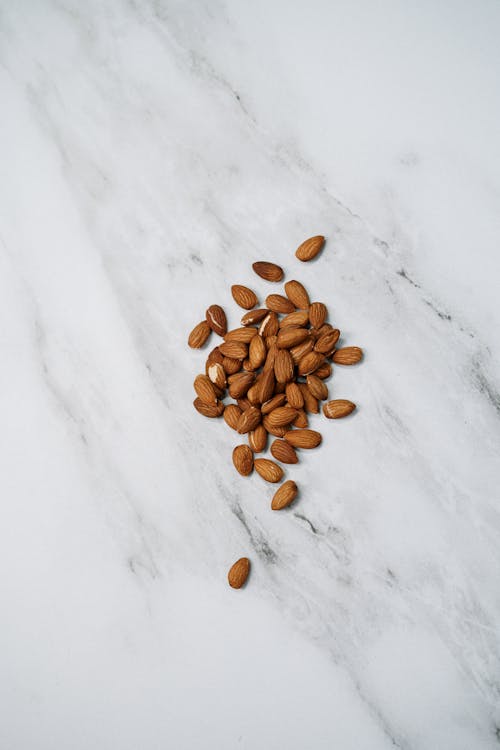 Free Almonds On White Surface Stock Photo