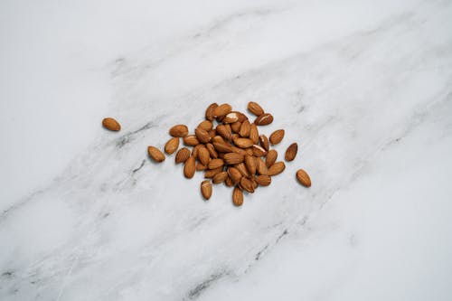 Brown Nuts On White Surface