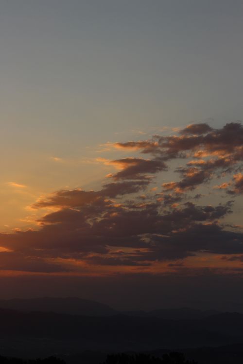 Free Breathtaking view of a sunset with clouds over rolling hills in Spain Stock Photo