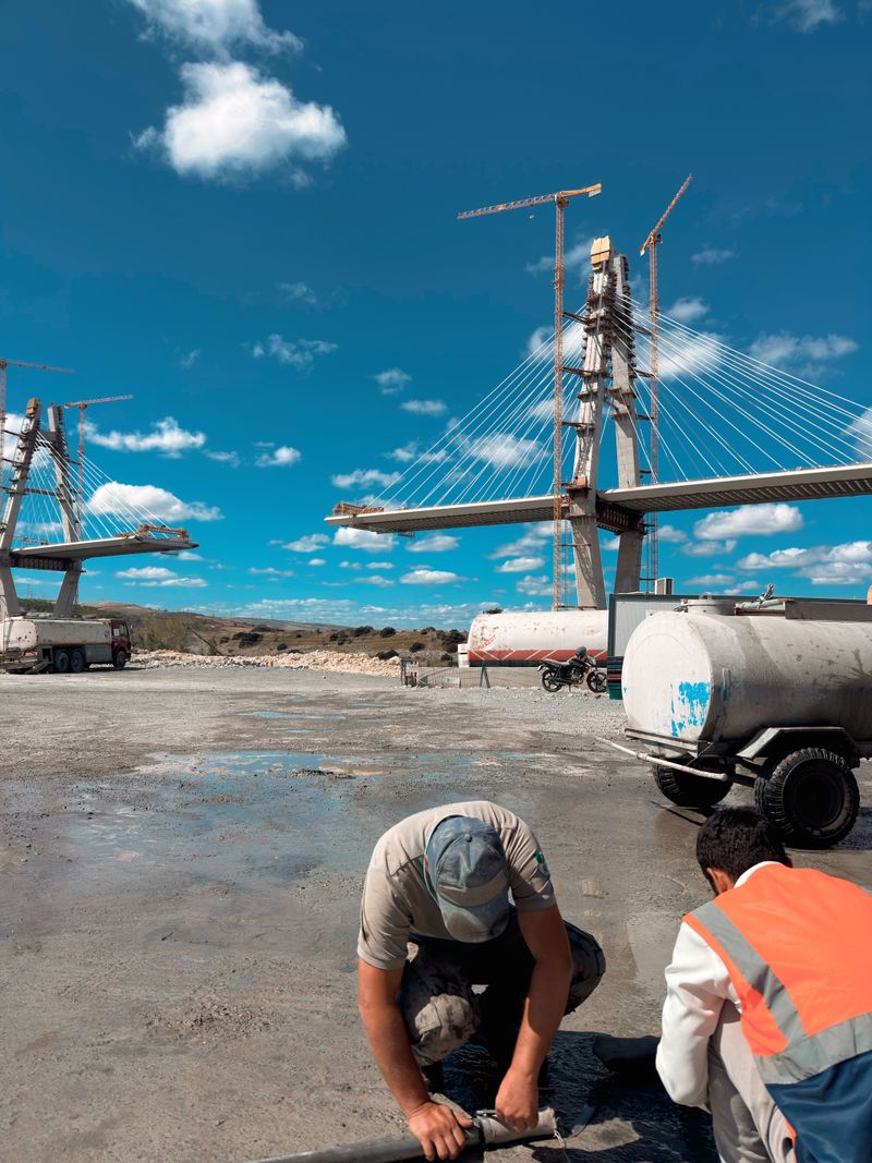 Workers preparing an infrastructure bridge construction site