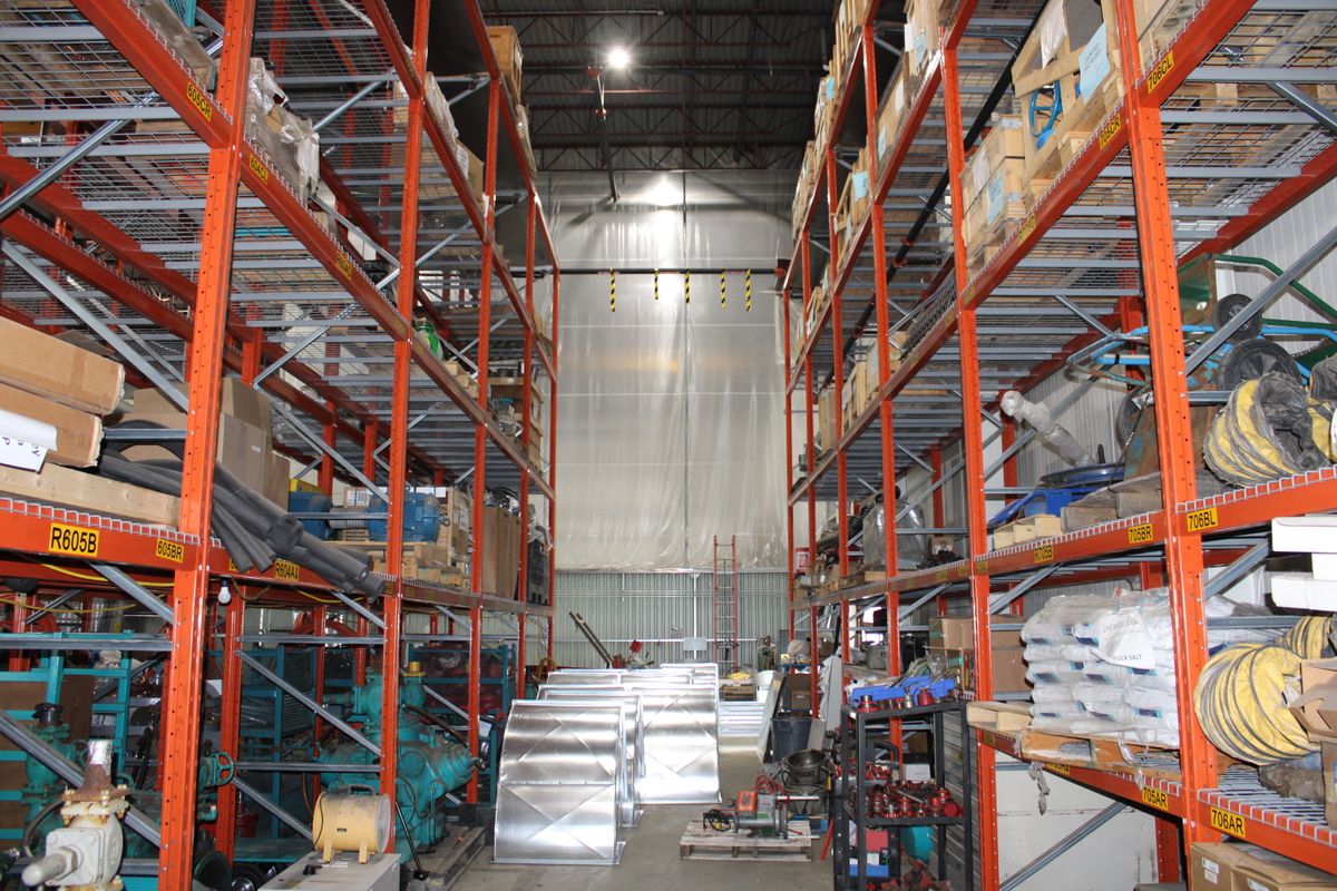 Interior view of a Burlington, Ontario warehouse showcasing industrial storage racks filled with various goods.