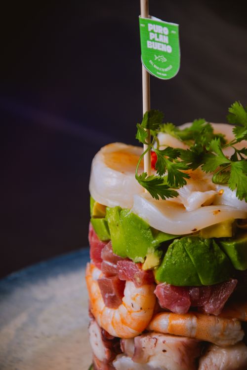 Free A colorful seafood tower with shrimp, avocado, cilantro, and scallops on a plate. Stock Photo