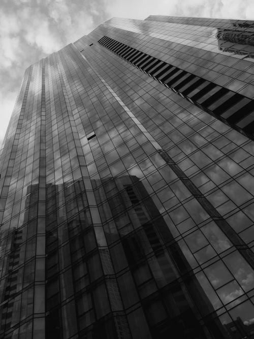 Free Stunning monochrome image showcasing a towering skyscraper in downtown Chicago reflecting the cloudy sky. Stock Photo