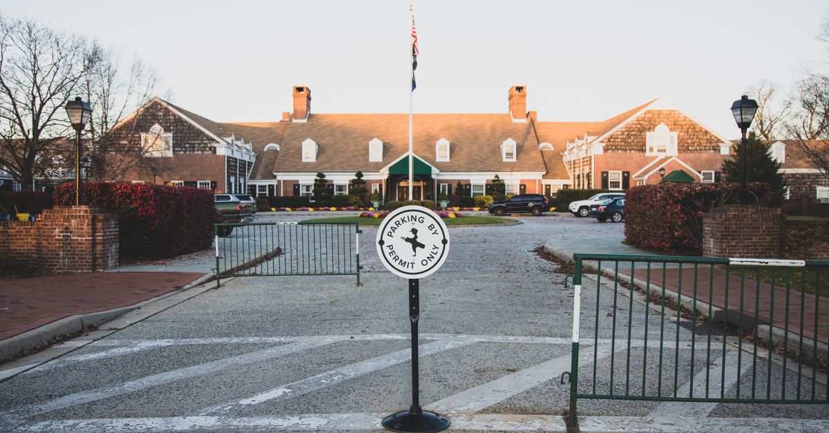 Cozy colonial-style brick building with parking sign, Farmingdale, NY