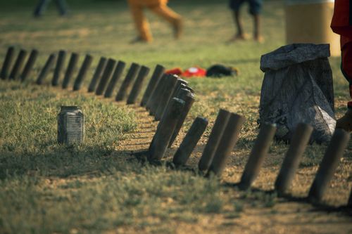 Free A creative outdoor setup with wooden posts and children playing in the background. Stock Photo