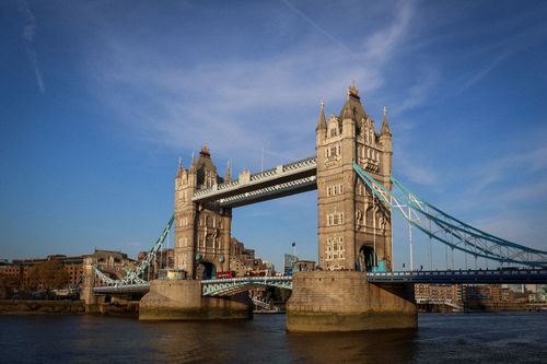 Free View of Tower Bridge in London with a clear blue sky, showcasing its iconic architecture. Stock Photo