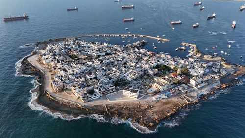Free Aerial image of Arwad Island, Tartus Governorate, Syria, surrounded by ships. Stock Photo