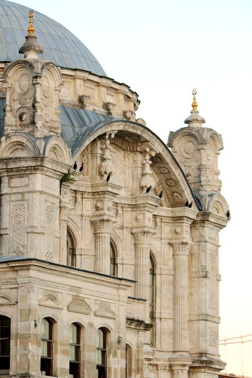 Free Intricate Neo-Baroque architectural facade with domes and sculptures at sunset. Stock Photo
