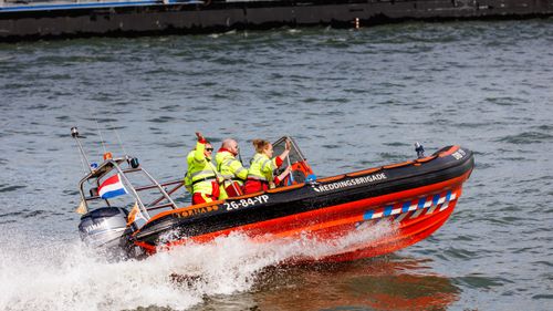 Free Exciting rescue training exercise at Rotterdam harbor with uniformed team. Stock Photo