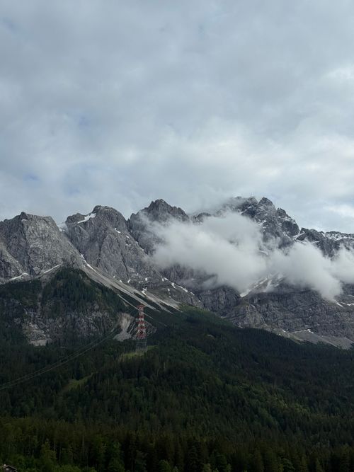Free Capture of a majestic mountain range with dramatic clouds hovering, offering a sense of mystery and awe. Stock Photo