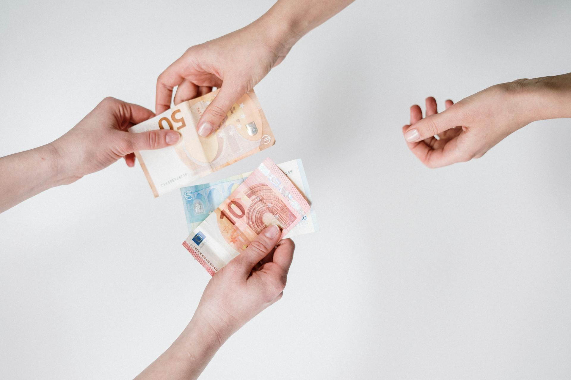 Person Holding 10 and 10 Banknotes