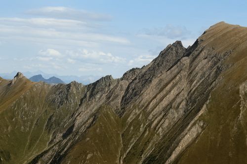 Free Breathtaking alpine mountain ridge under blue skies, showcasing impressive geology and beauty. Stock Photo