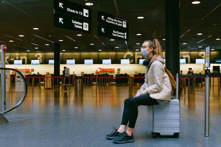 Woman Sitting On Luggage