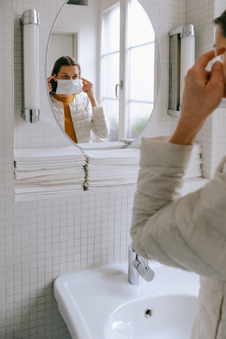 Person Putting On Face Mask