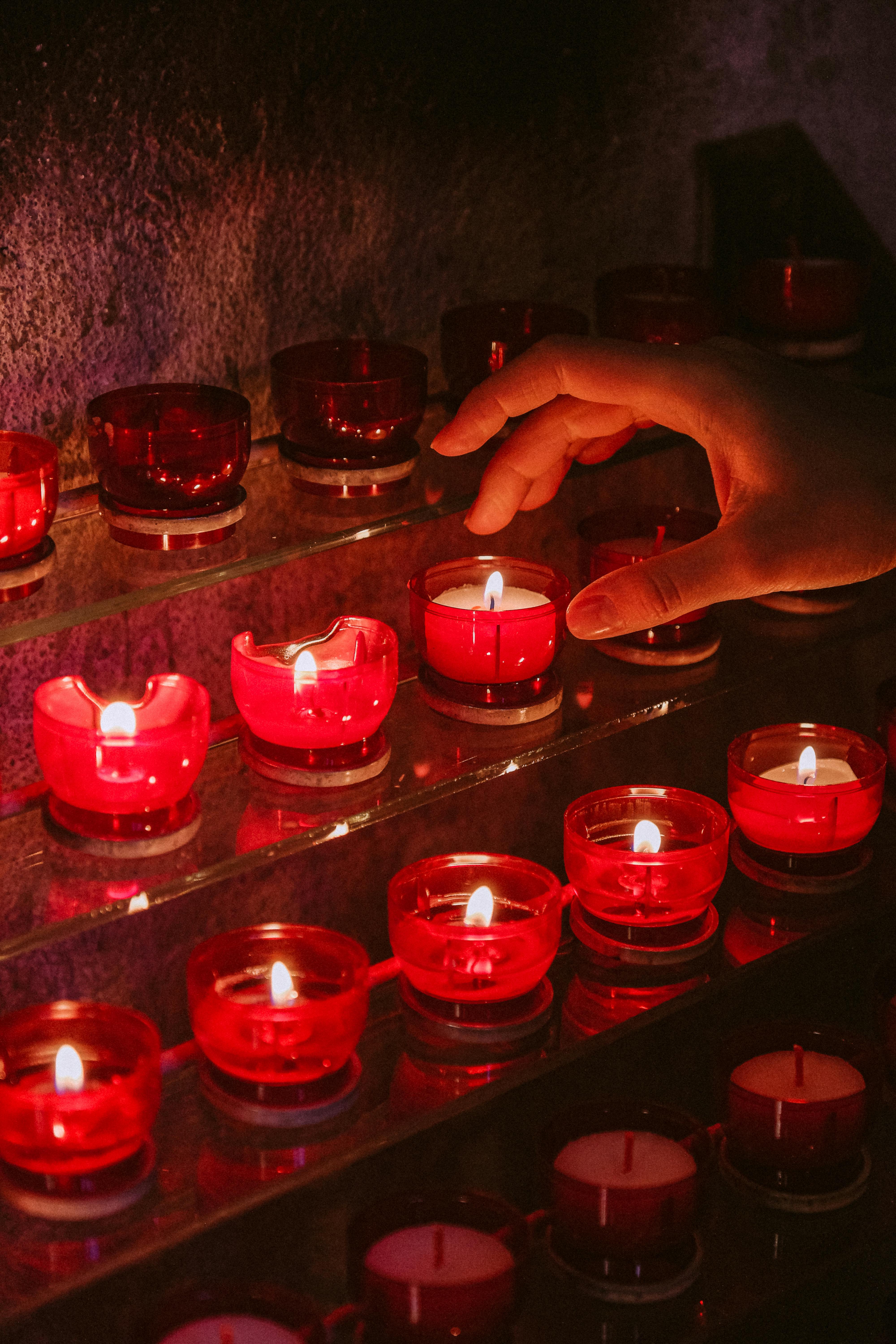 red candles on clear glass containers