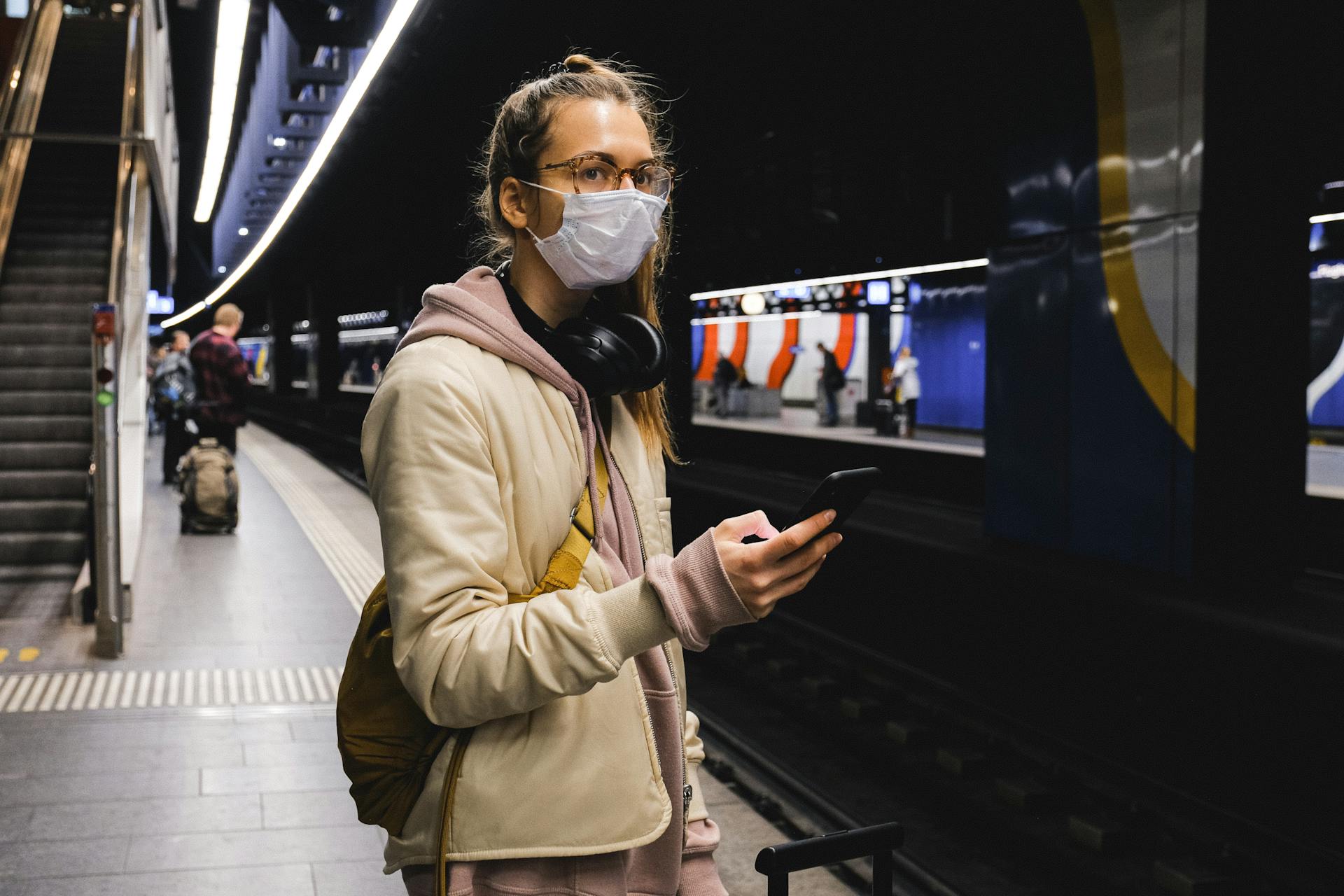 Woman With a Face Mask Standing on Train Station