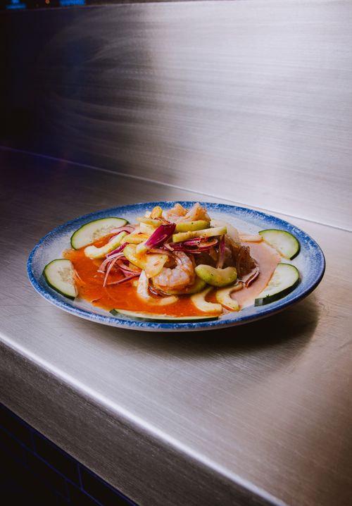 Free A vibrant plate of shrimp ceviche with fresh cucumbers and onions, served in a tangy sauce. Stock Photo