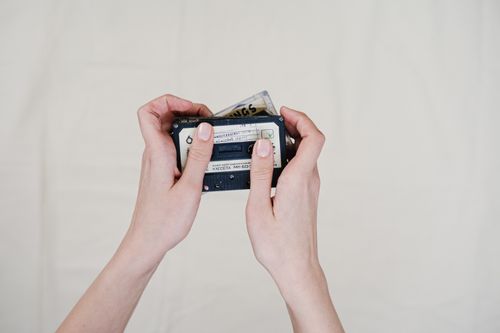 Free Close-up of hands holding vintage cassette tapes on a plain background, emphasizing retro music vibes. Stock Photo