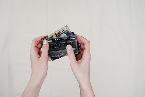 Person Holding Black Cassette Tape
