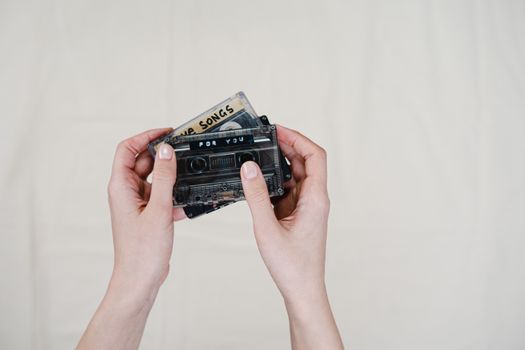 Person Holding Black Cassette Tape