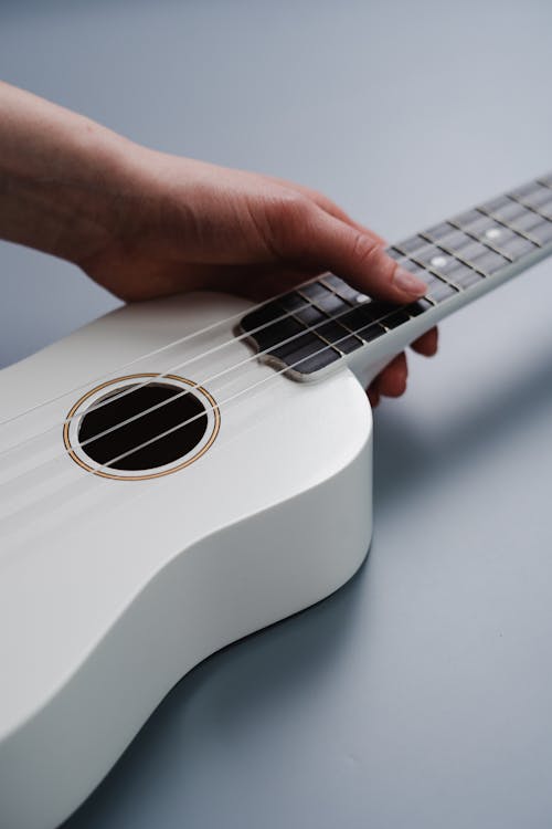 Person Holding White Acoustic Guitar