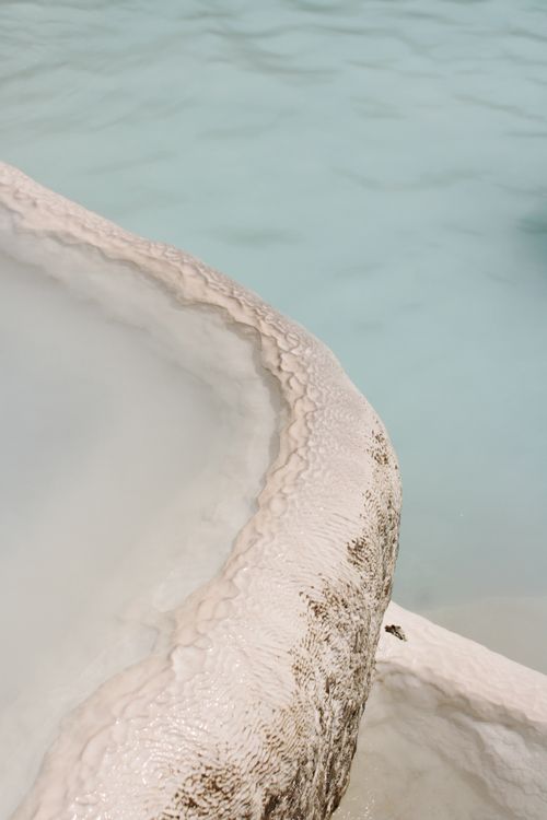 Free Close-up of mineral deposits at a natural thermal pool with turquoise water. Stock Photo