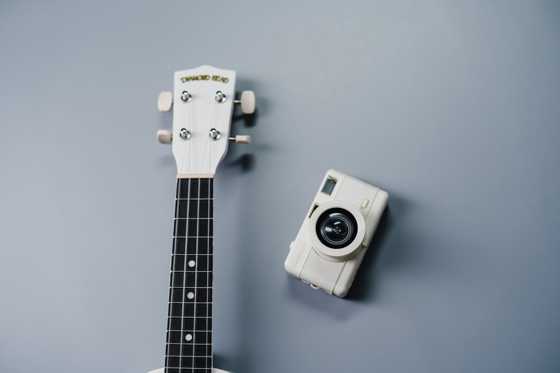 Free White and Black Camera on White Guitar Stock Photo