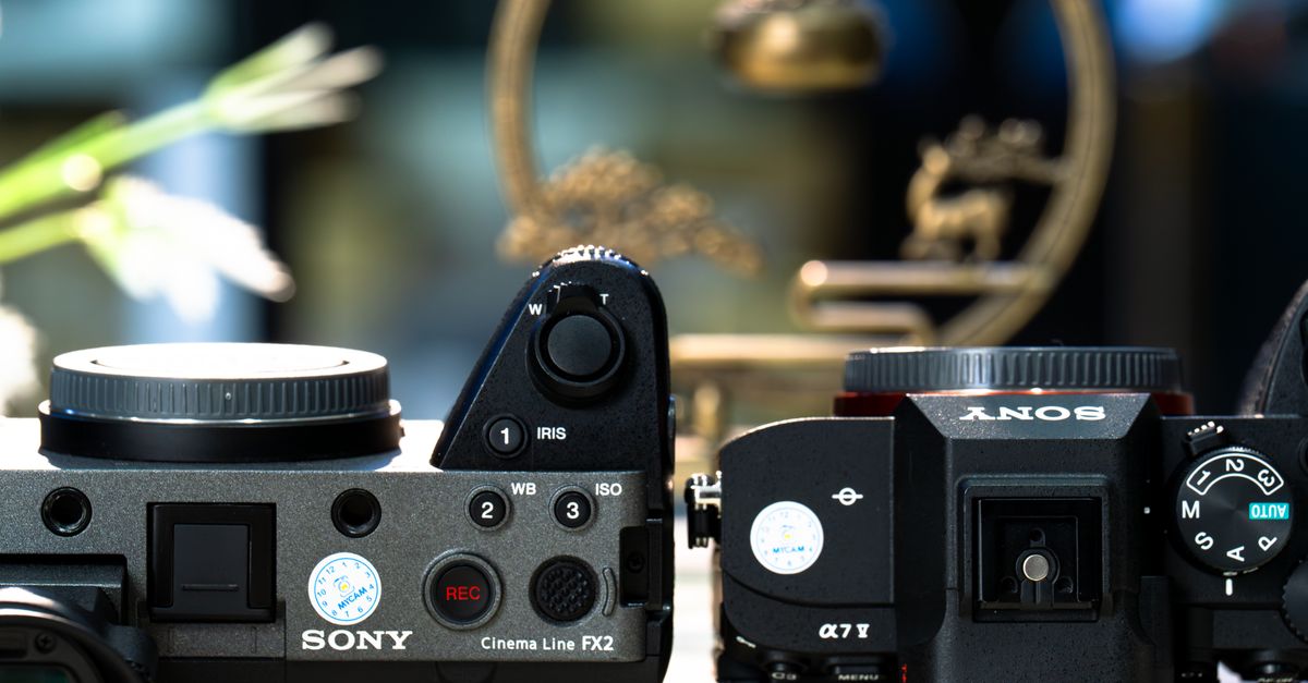 Close-up of two advanced digital cameras, showcasing design and controls.
