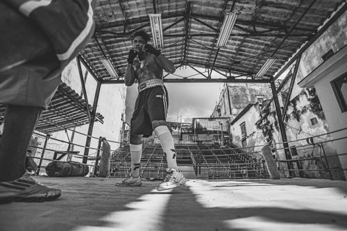 Free Black and white photo of a boxer training in an outdoor boxing ring in Cuba. Stock Photo