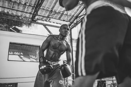 Free Black and white image of a male boxer in a Cuban gym, capturing the intensity and focus of the sport. Stock Photo