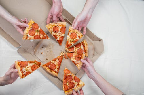 Free Photo Of People Holding Pizza  Stock Photo
