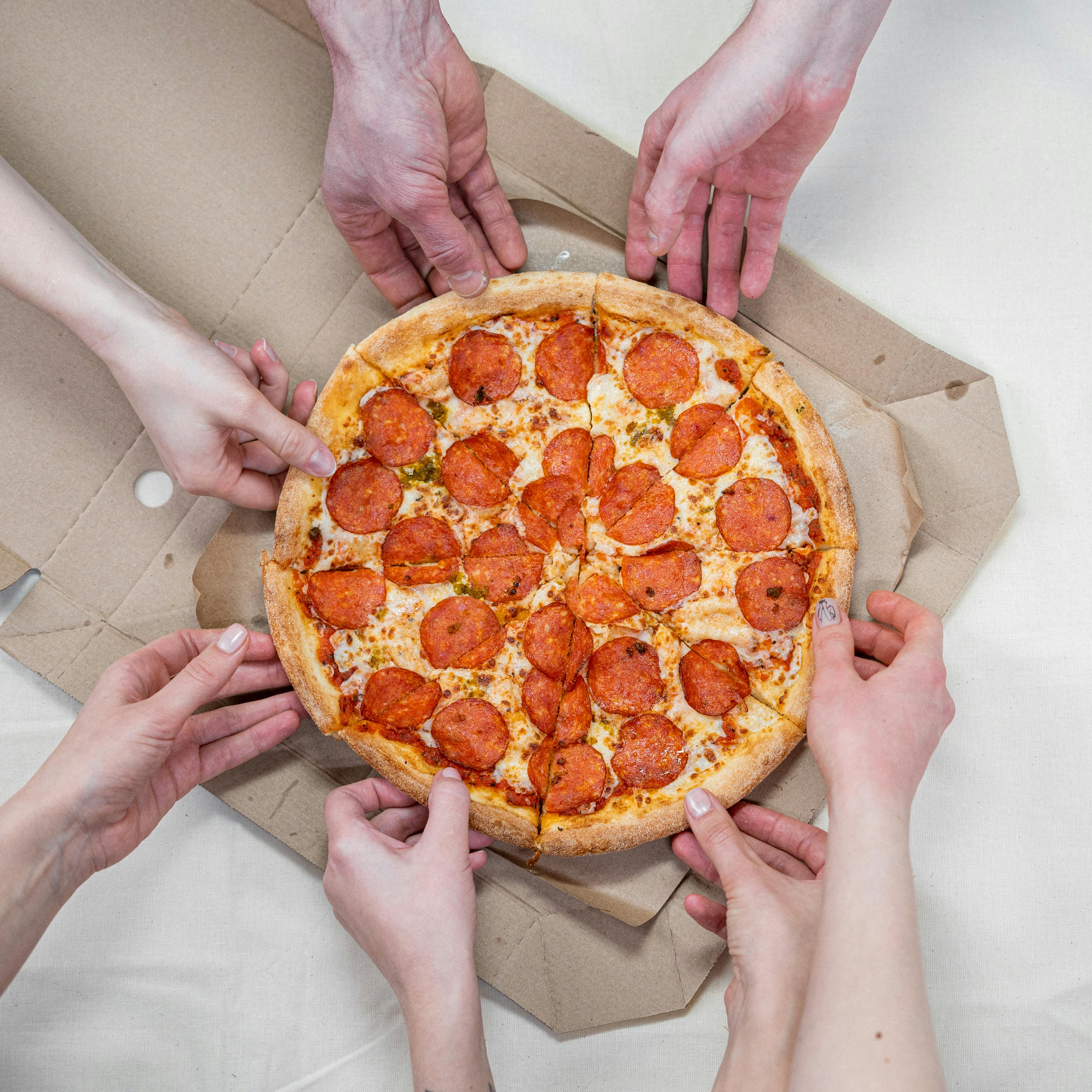 person-holding-pizza-with-cheese-free-stock-photo