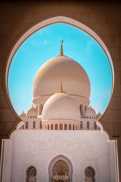 Free Stunning view of mosque dome architecture through an ornate archway in Dubai. Stock Photo