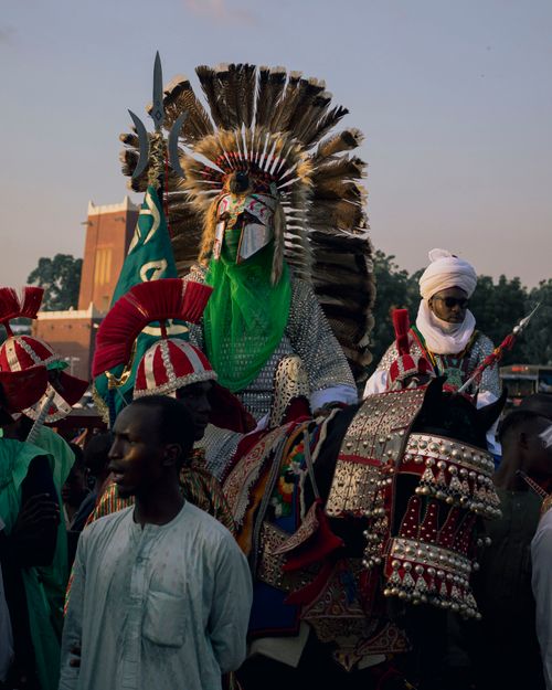Free Vibrant traditional festival featuring ornate costumes and headgear. Stock Photo