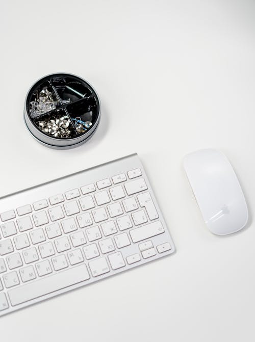Apple Magic Keyboard Beside Silver Round Analog Watch