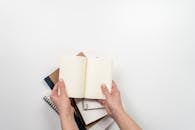 Person Holding A Blank Notebook